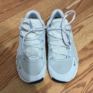 Nike womens Light Gray Sneakers with Gold Accents